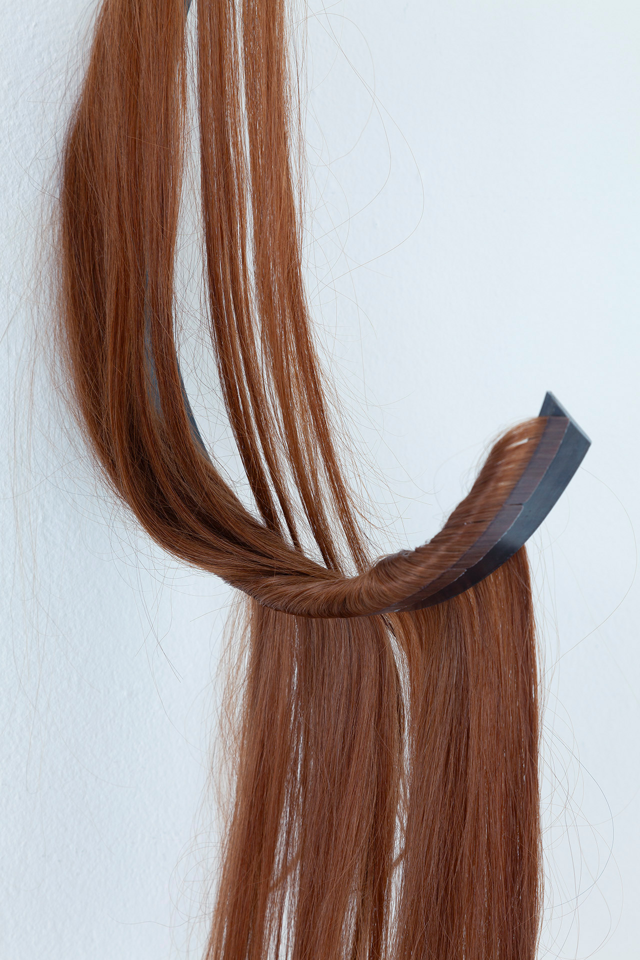 Close up. The Mess we're In II 2024 hairextension (real hair) and iron 75x32x12 cm