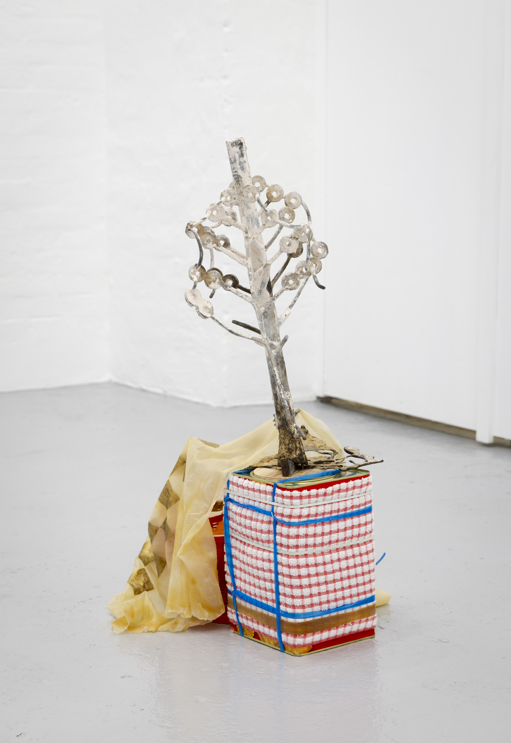 Kah Bee Chow, Money Tree (II), 2024, Cast bronze, plaster, chamotte, plywood, threaded rod, nuts, wood, concrete, raffia, dishcloth, rubber bands, biscuit tins, beeswax, plastic containers, faux oranges, and acrylic on latex, 70 x 45 x 50 cm